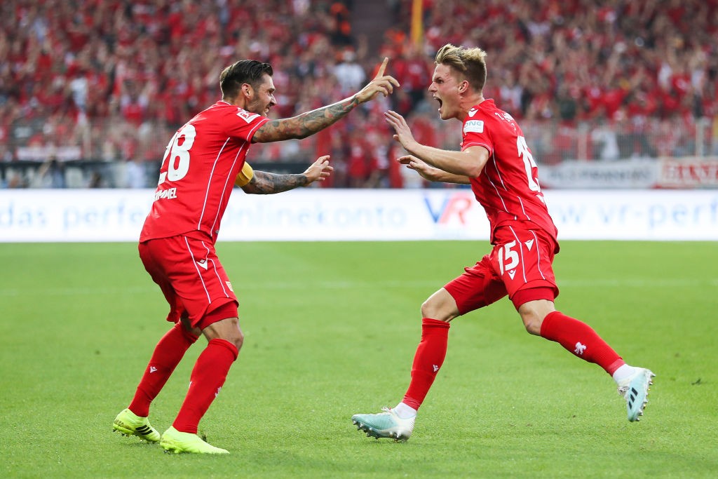 Marius Bulter (R) celebrates with his team mate Christopher Trimmel of FC Union Berlin after scoring his team's first goal during the Bundesliga match between 1. FC Union Berlin and Borussia Dortmund at Stadion An der Alten Foersterei on August 31, 2019 in Berlin, Germany. (Photo by Maja Hitij/Bongarts/Getty Images)