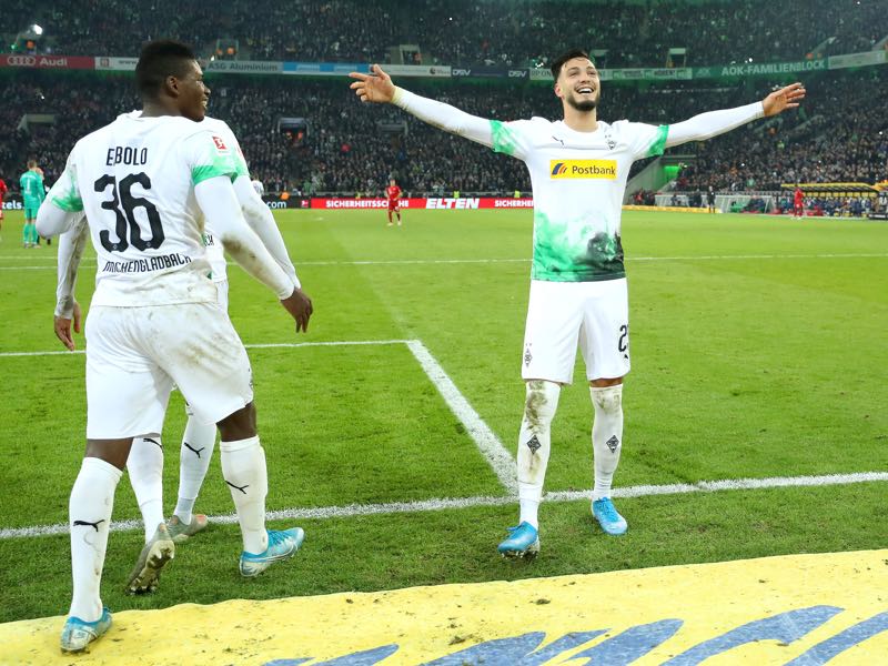 Ramy Bensebaini of Borussia Monchengladbach celebrates with Breel Embolo after scoring his team's second goal during the Bundesliga match between Borussia Moenchengladbach and FC Bayern Muenchen at Borussia-Park on December 07, 2019 in Moenchengladbach, Germany. (Photo by Lars Baron/Bongarts/Getty Images)